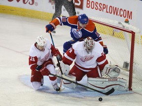 Nail Yakupov flies into the Detroit net as he's stopped by Red Wings goalie Petr Mrazek with the help of Tomas Tatar Wednesday at Rexall Place. Yakupov had a pair of assists in the game.  (Perry Mah, Edmonton sports)