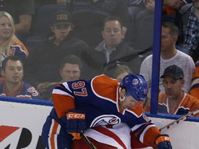 Connor McDavid, shown here battling Red Wings' Luke Glendening against the boards Wedensday, will face Alex Ovechkin when the Washington Capitals visit Rexall Place on Friday.