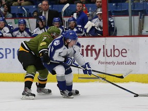 Miles Liberati, left, of the North Bay Battalion, attempts to strip the puck from Alan Lyszczarczyk, of the Sudbury Wolves, during OHL action at the Sudbury Community Arena in Sudbury, Ont. on Friday October 16, 2015. John Lappa/Sudbury Star/Postmedia Network