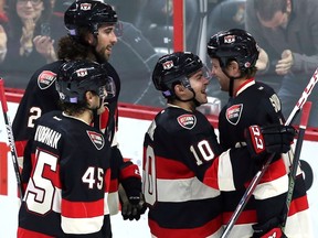 Ottawa Senators' Zack Smith (15) celebrates his goal with teammates Shane Prince (10) Chris Wideman (45) and Jared Cowen (2) during NHL hockey second period action against the New Jersey Devils in Ottawa Thursday October 22, 2015. THE CANADIAN PRESS/Fred Chartrand