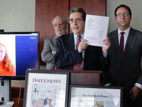 Attorney Norman Siegel, center, along with Udi Ofer, right, executive director of the American Civil Liberties Union of New Jersey, and attorney Steven Hyman, answers questions during a news conference, Thursday, Oct. 22, 2015, in New York. The ACLU along with two New York law firms, will be representing Kaci Hickox, seen at left via Skype,  in filing a lawsuit against Gov. Chris Christie and health officials. Hickox was the nurse who was detained last year after returning from treating Ebola patients in Sierra Leone. (AP Photo/Julie Jacobson)