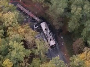 This aerial photo taken from video, shows the scene after a truck and a bus transporting retirees on a day trip collided and caught fire Friday in wine country in southwest France, killing 42-people and badly injuring four others, authorities said, on Oct. 23, 2015. (iTélé FRANCE TV via AP)