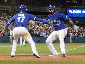 Ryan Goins and Jose Bautista of the Toronto Blue Jays celebrate Bautista's home run against the Texas Rangers during the ALDS Game 5 at the Rogers Centre in Toronto, Ont. on Wednesday October 14, 2015. Stan Behal/Toronto Sun/Postmedia Network