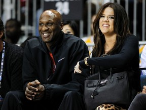 Los Angeles Lakers' Lamar Odom and his wife television personality Khloe Kardashian sit courtside as they attend the 2011 BBVA All-Star Celebrity basketball game as a part of the NBA All-Star basketball weekend in Los Angeles, in this February 18, 2011, file photo. Khloe Kardashian and her basketball player husband Lamar Odom called off their divorce on October 21, 2015 a week after the athlete collapsed into a coma in Las Vegas, celebrity media reported.   REUTERS/Danny Moloshok/Files