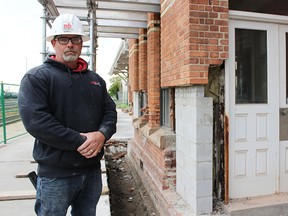 Norlon Builders' Shawn Monkman stands by a partially rusted doorway at Sarnia's train station. Monkman is one of several people involved in a project to restore the 1891-built train station. (Tyler Kula/Sarnia Observer/Postmedia Network)