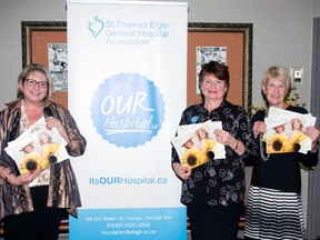 ETG president Lesley Chapman, left, and STEGH Foundation reps Chris Stinson and Susan O'Brien at Oct. 10 launch of Ladies of Elgin calendar.