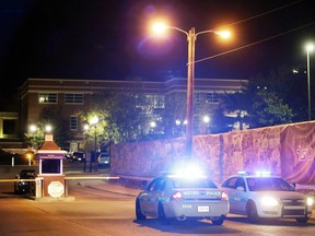 Police guard the main entrance to Tennessee State University early Friday, Oct. 23, 2015, while officials investigate the scene of a Thursday shooting on the campus in Nashville, Tenn. Authorities say one person was killed and two others hospitalized in the shooting at an outdoor courtyard. A campus spokesperson said the person killed wasn't enrolled at the school. (AP Photo/Mark Humphrey)
