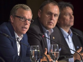 Saskatchewan Premier Brad Wall, left, fields a question as Nunavut Premier Peter Taptuna, right, and Yukon Premier Darrell Pasloski look on at the closing news conference of the summer meeting of Canada's premiers in St. John's on July 17, 2015. (THE CANADIAN PRESS/Andrew Vaughan)