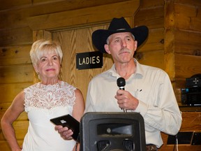 Anne Coles, president of the ATA, presents Brent Sinclair, president of the SCTA, with one of two awards he won at the local association’s annual general meeting and banquet. Above: Don Brestler entertains with a song. John Stoesser photos/Pincher Creek Echo