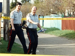 52-year-old  Adolph Gurnick unsolved May 2, 1992 homicide. Edmonton Police Service member Bill Clark (right) and another officer investigate the homicide of Adolph Gurnick in Edmonton Alta. on May 2, 1992. Gurnick was found in the lane at 12943-122 Street. An autopsy revealed he had been beaten, and suffered numerous stab wounds. A reward of $40,000.00 is still available for information leading to the apprehension and conviction of the person or persons responsible for this crime. Edmonton Sun/QMI Agency