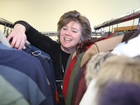 Jason Miller/The Intelligencer
Salvation Army director, Abby Mills, sort through coats already donate for this year’s Coats for Folks program. The program is less than halfway from the 250 to 300 coat donation marker.