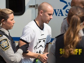 William Sandeson, charged with first-degree murder in the death of fellow Dalhousie University student Taylor Samson, is escorted from Nova Scotia provincial court in Halifax on Wednesday, September 2, 2015. THE CANADIAN PRESS/Andrew Vaughan