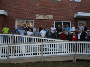 Renovators pose during a break in their work day at Pilgrims Hospice on Oct. 22.
