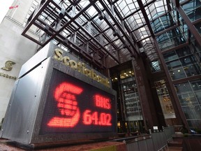 An electronic sign posting financial data is shown outside the Scotiabank building in Toronto, Thursday, April 9, 2015. Scotiabank is telling employees to get ready for certain offices to close over the next two years as it concentrates its workforce in two new hubs with more advanced technology. (THE CANADIAN PRESS/Frank Gunn)