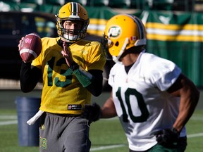 Mike Reilly, shown here throwing to Chad Simpson at practice Wednesday, says the Eskimos are capable of putting up big points when they play with discipline. (David Bloom, Edmonton Sun)