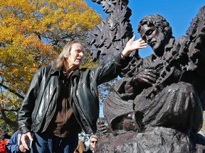 Singer Gordon Lightfoot stands with the statue of him by sculptor Timothy Schmalz that was unveiled in his hometown of Orillia on Oct. 23, 2015. (Michael Peake/Toronto Sun)