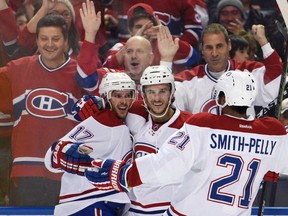 Canadiens' Torrey Mitchell (17), Brian Flynn (32) and Devante Smith-Pelly (21) celebrate Mitchell's goal during second period NHL action against the Sabres in Buffalo, N.Y., on Friday, Oct. 23, 2015. (Gary Wiepert/AP Photo)