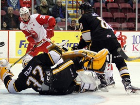 Soo Greyhounds forward Bryce Yetman looks for an opening as Sarnia Sting goaltender  Justin Fazio and defanceman Josh Jacobs block the net during first-period action Friday, Oct. 23, 2015 at Essar Centre in Sault Ste. Marie, Ont. (JEFFREY OUGLER, Postmedia Network)