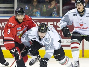 London Knights forward Christian Dvorak and Owen Sound Attack forward Ethan Szypula battle for the puck after a faceoff during their OHL game at Budweiser Gardens on Friday. (CRAIG GLOVER, The London Free Press)