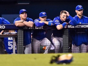 Toronto Blue Jays teammates look on after being defeated by the Kansas City Royals during ninth inning game six American League Championship Series baseball action in Kansas City, Mo., on Friday, October 23, 2015. (THE CANADIAN PRESS/Nathan Denette)