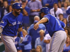 Jose Bautista and Ben Revere of the Toronto Blue Jays celebrates Jose Bautista second home run evening the score at 3-3 against the Kansas City Royals during game 6 of the American League Championship Series at Kauffman Stadium in Kansas City, MO, USA. on Friday October 23, 2015. (Dave Abel/Toronto Sun/Postmedia Network)