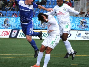 Edmonton FC Eddies' Albert Watson heads the ball past New York Cosmos' defenders at Clarke Park on September 27, 2015 in Edmonton, Alta.  Perry Mah/Edmonton Sun/Postmedia