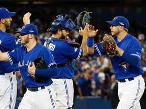 Many players from the Toronto Blue Jays' largely successful 2015 roster remain under contract, including Chris Colabello, left, Josh Donaldson, second from left, and Justin Smoak, right. Players that will become free agents this off-season include Dioner Navarro, second from right. (Stan Behal/Toronto Sun/Postmedia Network)