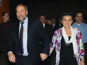 NDP leader Thomas Mulcair and wife Catherine Pinhas leave the NDP federal election night headquarters in Montreal, Monday, October 19, 2015. THE CANADIAN PRESS/Graham Hughes
