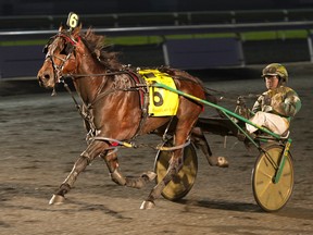 Boston Red Rocks, driven by Tim Tetrick, produced an 18-1 upset in the $778,400 Two-Year-Old Colt Trot on Saturday night at the Breeders’ Crown at Woodbine. (MICHAEL BURNS/PHOTO)