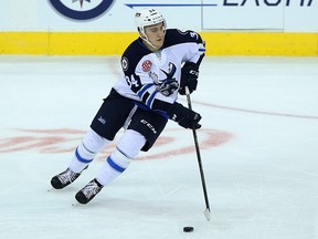 Manitoba Moose forward JC Lipon carries the puck up ice during AHL action against the Ontario Reign at MTS Centre in Winnipeg on Thu., Oct. 15, 2015. Kevin King/Winnipeg Sun/Postmedia Network