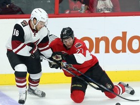 Arizona Coyotes' Max Domi (16) and Ottawa Senators' Curtis Lazar (27) battle for the puck during first period NHL hockey action in Ottawa Saturday, October 24, 2015. 
THE CANADIAN PRESS/Fred Chartrand