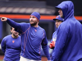 New York Mets second baseman Daniel Murphy, left, talks with teammates during a baseball workout in New York on Oct. 24, 2015. (AP Photo/Julie Jacobson)