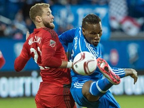 Montreal Impact's Didier Drogba, right, challenges Toronto FC's Josh Williams during first half MLS soccer action in Montreal on Oct. 25, 2015. (THE CANADIAN PRESS/Graham Hughes)