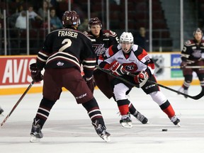 Ottawa 67's forward Austen Keating fends off Dominik Masin of the Peterborough Petes during OHL action at TD Place on Sunday, Oct. 25, 2015. (Chris Hofley/Ottawa Sun)