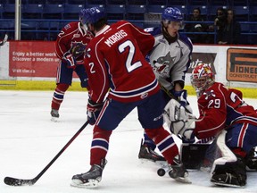 Sudbury Wolves forward Michael Pezzetta, centre, tries to feed a puck through the crease while Hamilton Bulldogs defenceman Brody Morris and goaltender Connor Hicks protect the goal during OHL action at Sudbury Community Arena on Sunday night. Ben Leeson/The Sudbury Star/Postmedia Network
