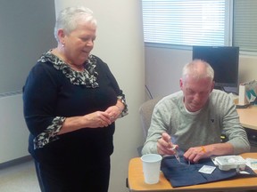 Photo supplied
Patient Michael Mangan demonstrates an infusion treatment, along with Betty Ann Paradis, registered nurse.