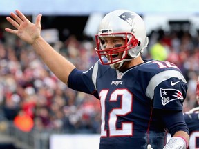 Tom Brady  reacts after throwing a touchdown pass during the fourth quarter against the New York Jets at Gillette Stadium  in Foxboro, Mass., on Oct. 25, 2015. (Jim Rogash/Getty Images/AFP)