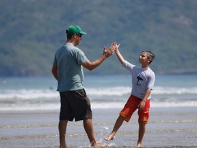 Derek Firth, who is raising money to support children and teens with autism through sports programs, is shown here with his son.
(Submitted photo, Badfish Photography)