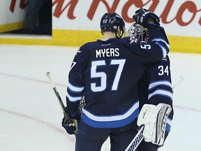 Winnipeg Jets defenceman Tyler Myers congratulates goaltender Michael Hutchinson on a victory over the Minnesota Wild in NHL action in Winnipeg on Sun., Oct. 25, 2015. Kevin King/Winnipeg Sun/Postmedia Network