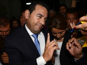 Jimmy Morales, the National Front of Convergence party presidential candidate, talks with reporters upon his arrival to the Electoral Supreme Court headquarters in Guatemala City, Sunday, Oct. 25, 2015. Morales, a TV comedian, was elected as Guatemala's next president in a landslide Sunday, riding a wave of popular anger against the political class after huge anti-corruption protests helped oust the last government. (AP Photo/Oliver de Ros)