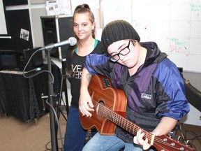 Rachael Spiece and Jess Anthony strum a few bars in preparation for Open Mic Night at Sarnia Lambton Rebound's r.LOUNGE. The recently launched lounge is a safe space for youth aged 12 and up. (Carl Hnatyshyn, Postmedia Network)