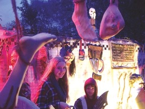 Scotlynn Belding (left) and Addison Jones pose with chainsaw and machete props in the 'chop shop' at the McCarey Haunted House, located at 6 Third Concession Road, between Simcoe Street and Mall Road, near the Norfolk Mall. The haunted house will be open 7-9 p.m. each night from Oct. 24-31 (opening earlier on Halloween). Admission is a donation for the local food bank.