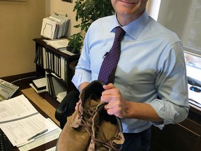 Alberta Finance Minister Joe Ceci in keeping with the unusual Canadian parliamentary tradition of getting new shoes before tabling a budget, Ceci pulled out a pair of his father's old work boots to show the NDP government's first fiscal plan is thinking about families in Edmonton on Monday Oct. 26, 2015. Matthew Dykstra/Edmonton Sun