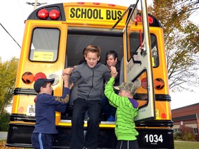 Grade 7 students Mark Knill and Kurtis DeJong helped their classmate Evan MacArthur perform a rear bus evacuation, with the guidance of bus driver Lora-Lee Simpson, Oct. 20 as part of Murphy Bus Line's bus evacuation session at Mitchell District High School. GALEN SIMMONS/MITCHELL ADVOCATE