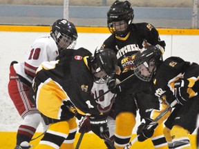 Members of the Mitchell Atom AE's scramble for the puck during early season action. ANDY BADER/MITCHELL ADVOCATE