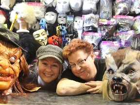 Audrey's Costume Castle employee Tammy McPhalen, left, and manager Sue Brites join a couple of their store's characters in Kingston on Monday as they gear up for Halloween. (Michael Lea/The Whig-Standard)