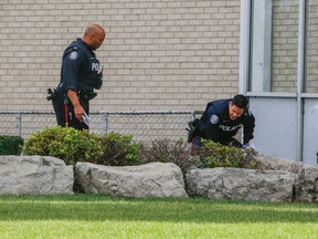 Toronto Police investigate the scene at Treewood St. and Brockley Dr., in the Lawrence and Midland area in Toronto, where a 14-year-old boy was found with a stab wound Monday October 26, 2015. (Dave Thomas/Toronto Sun)