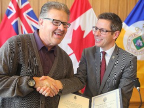 Dancing Gabe Langlois (left) received a Community Service Award from Mayor Brian Bowman on Monday. (Brian Donogh/Winnipeg Sun)