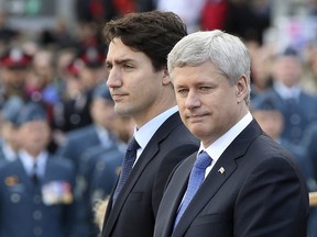 Prime Minister Stephen Harper, right, and Prime Minister-designate Justin Trudeau take part in a ceremony to commemorate the October 2014 attack on Parliament Hill, at the National War Memorial in Ottawa, Canada October 22, 2015. The event also honoured the lives of Warrant Officer Patrice Vincent and Corporal Nathan Cirillo, two soldiers killed in a pair of separate attacks police said were carried out independently by radical recent converts to Islam. (REUTERS/Chris Wattie)