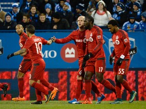 Toronto FC forward Jozy Altidore reacts with teammates including Michael Bradley and Sebastian Giovinco after scoring a goal against the Montreal Impact during the first half at Stade Saputo on Oct. 25, 2015. (Eric Bolte/USA TODAY Sports)